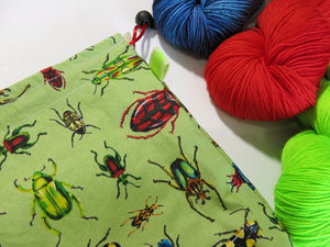green cotton knitting project bag with colourful beetles and insects