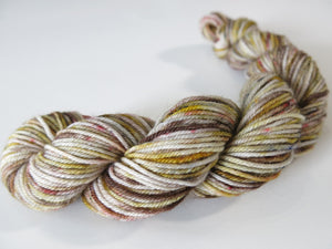 grey brown sock yarn mini skein with red and black speckles