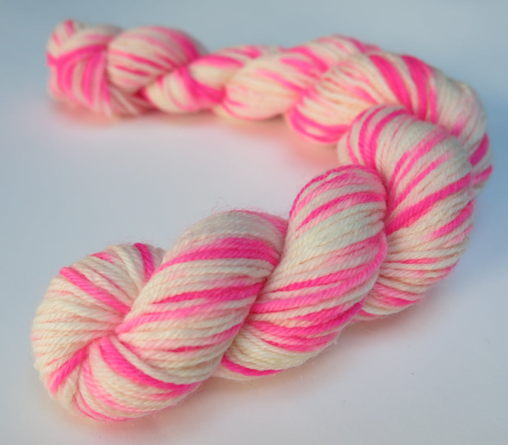 bright neon pink and white sock yarn mini skein for knitting and crochet