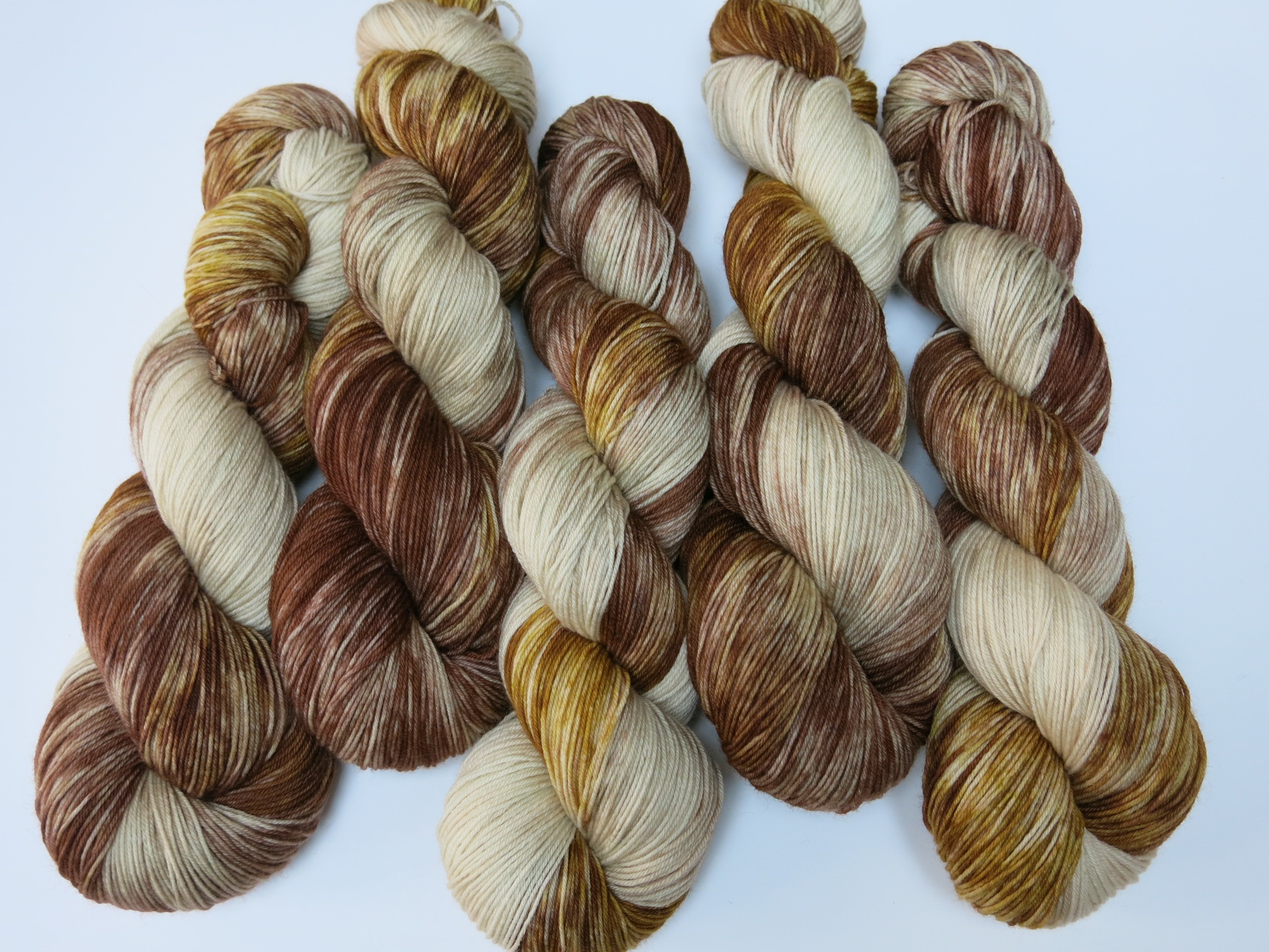hand dyed superwash merino and nylon sock yarn in browns and creams