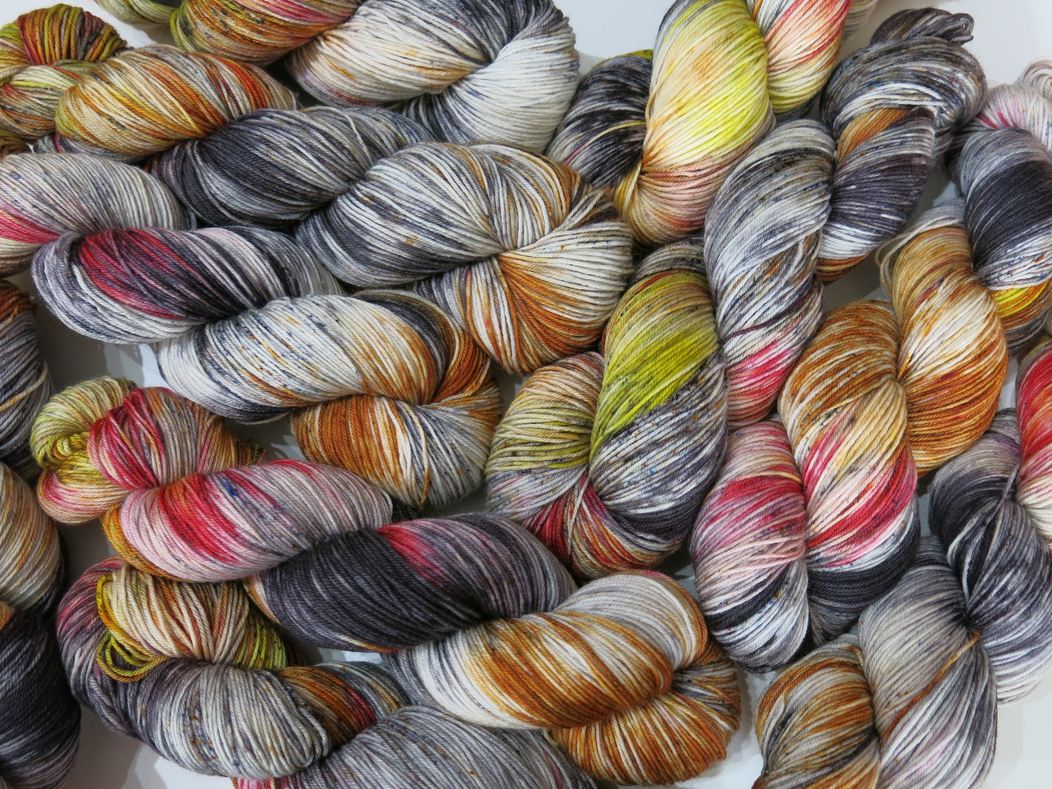 hand dyed yarn with black speckles and fire reds and yellows