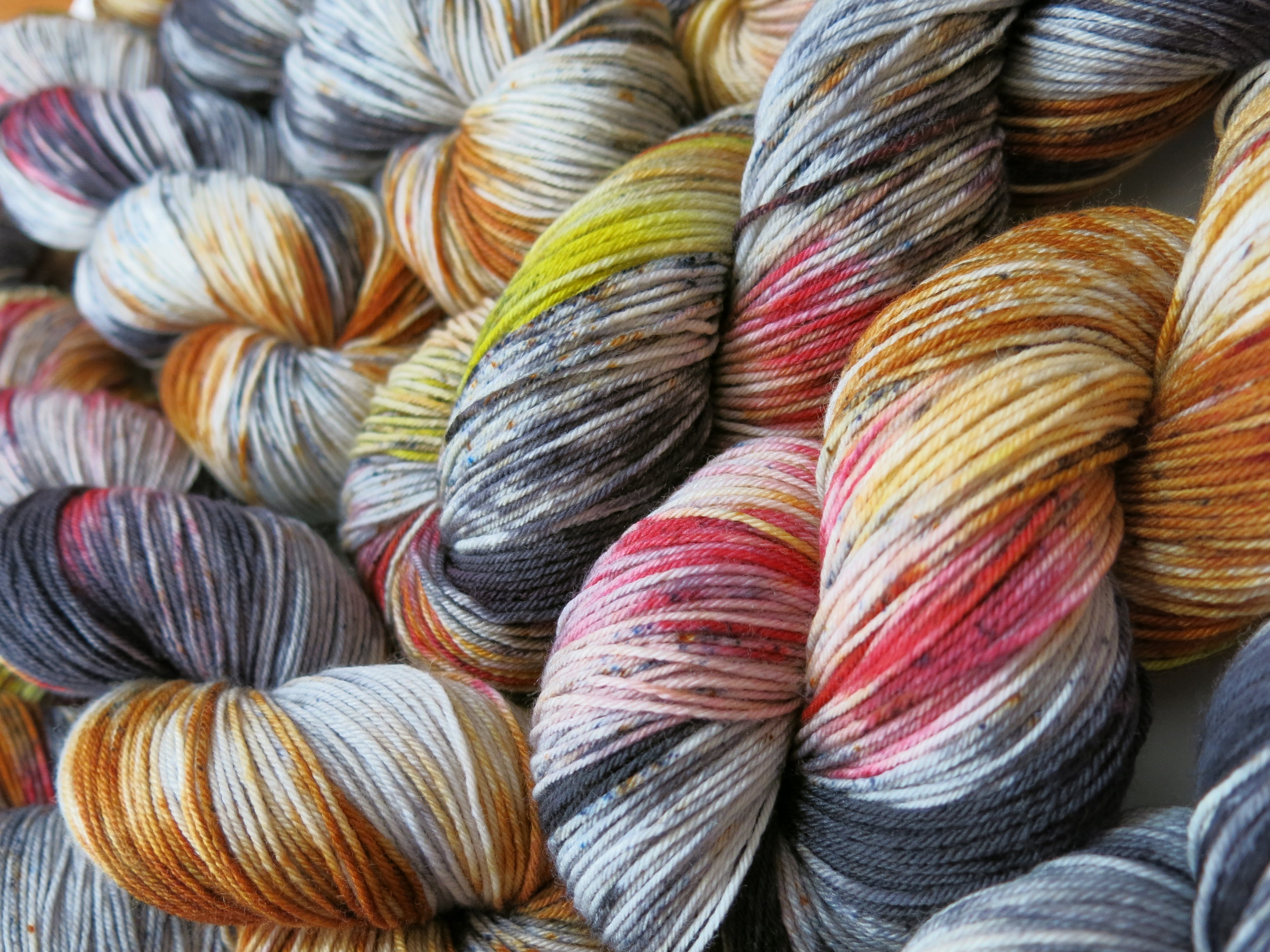 indie dyed yarn with black speckles and fire reds and yellows