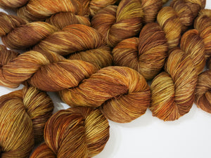 hand dyed yarn in willow basket browns and reds