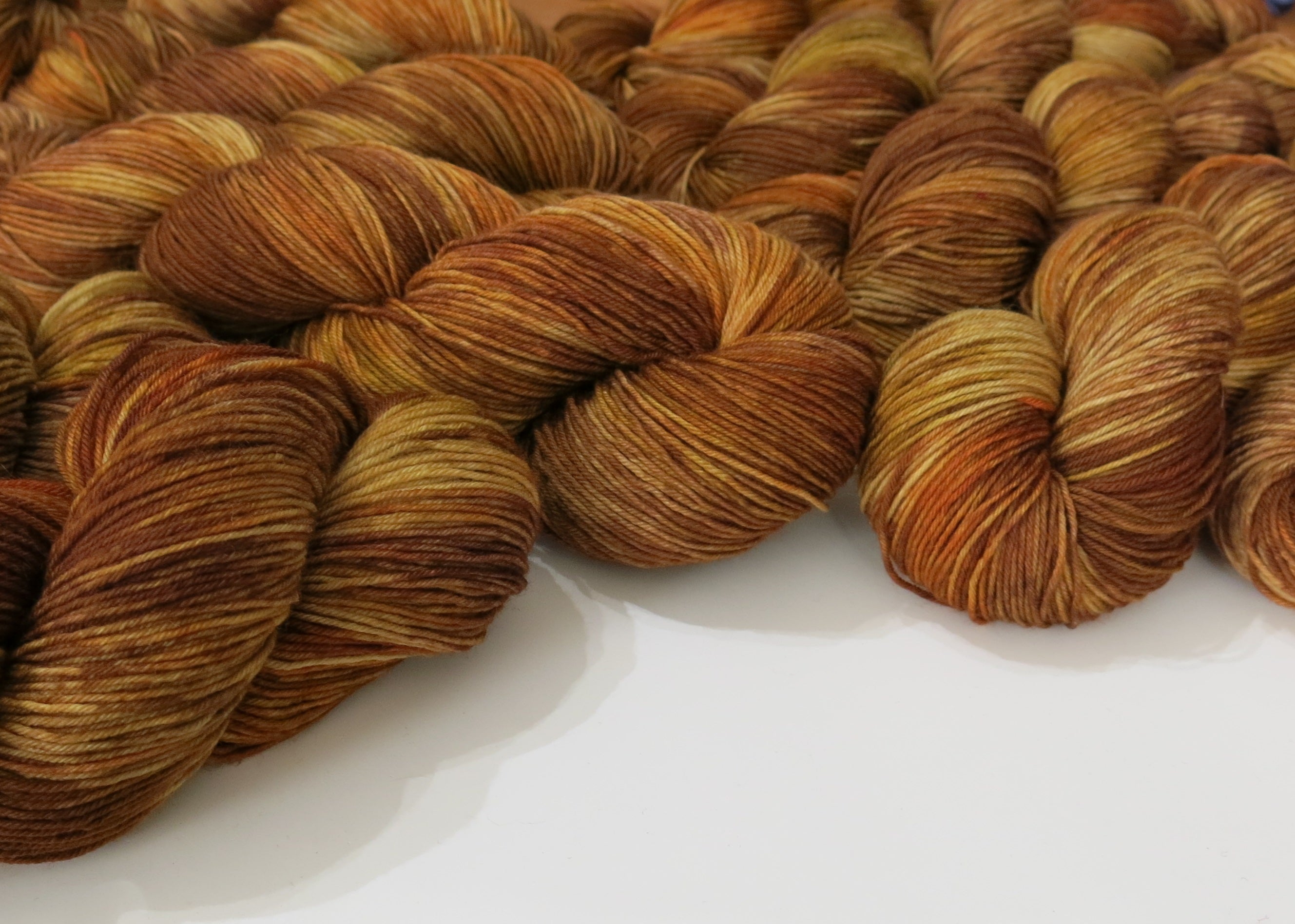indie dyed yarn in reds, browns and yellows insoired by scottish willow back creels