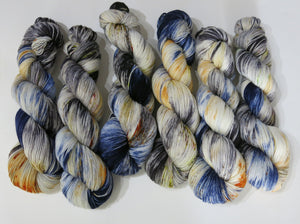 indie dyed yarn with specles and black and blue pools of colour