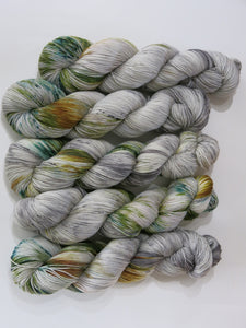 pale grey yarn with speckles of yellow and forest green by my mama knits