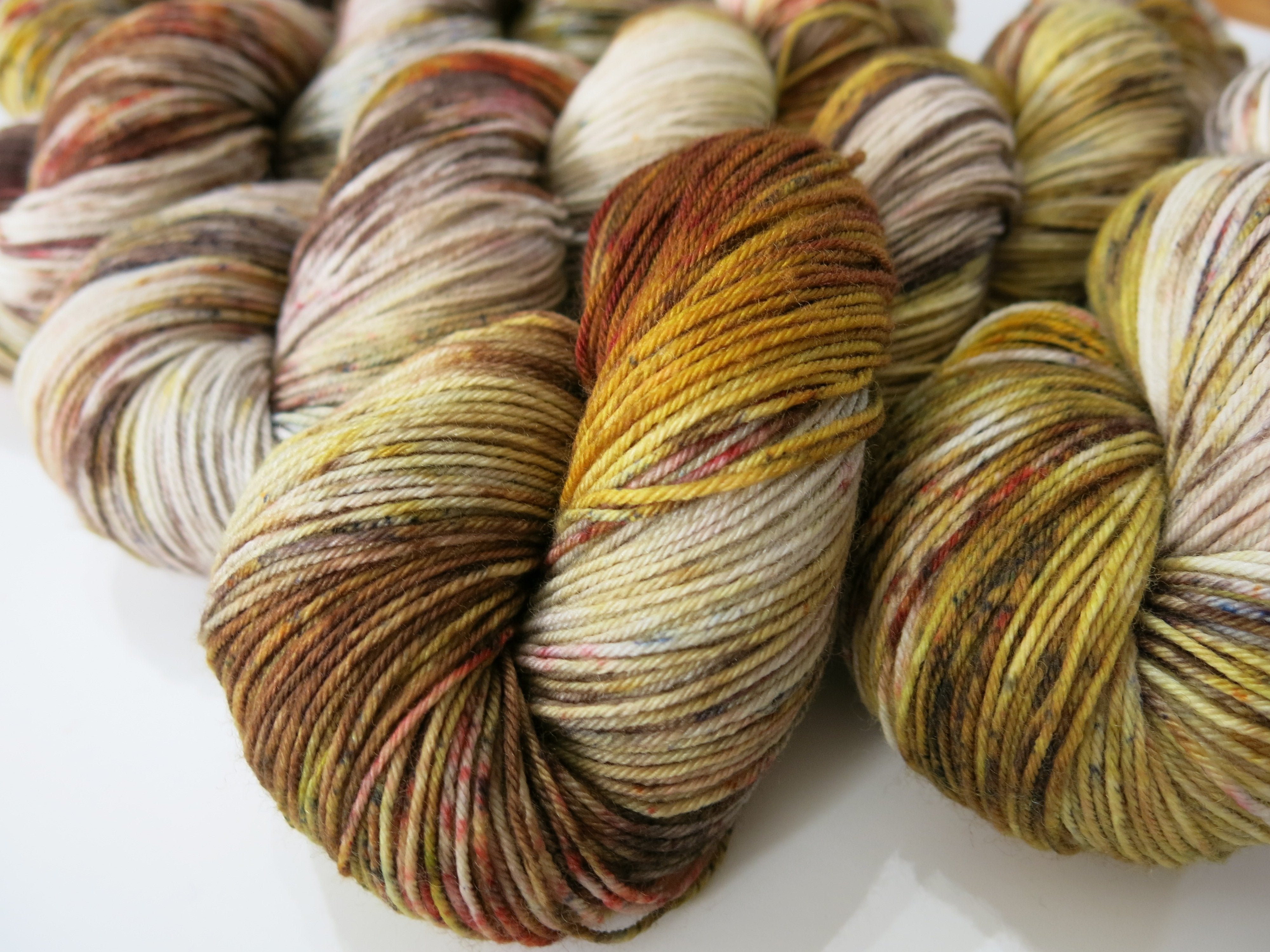 hand dyed speckled yarn skeins in browns and greys