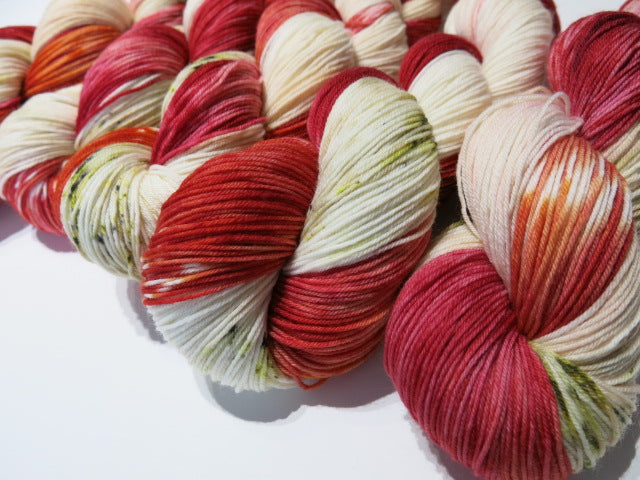 fly agaric mushroom sock yarn skeins with reds and creams