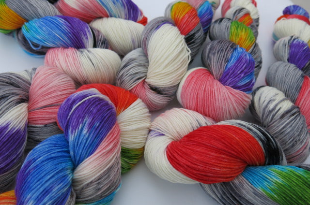 sock yarn skeins with rainbow colours and grey speckles
