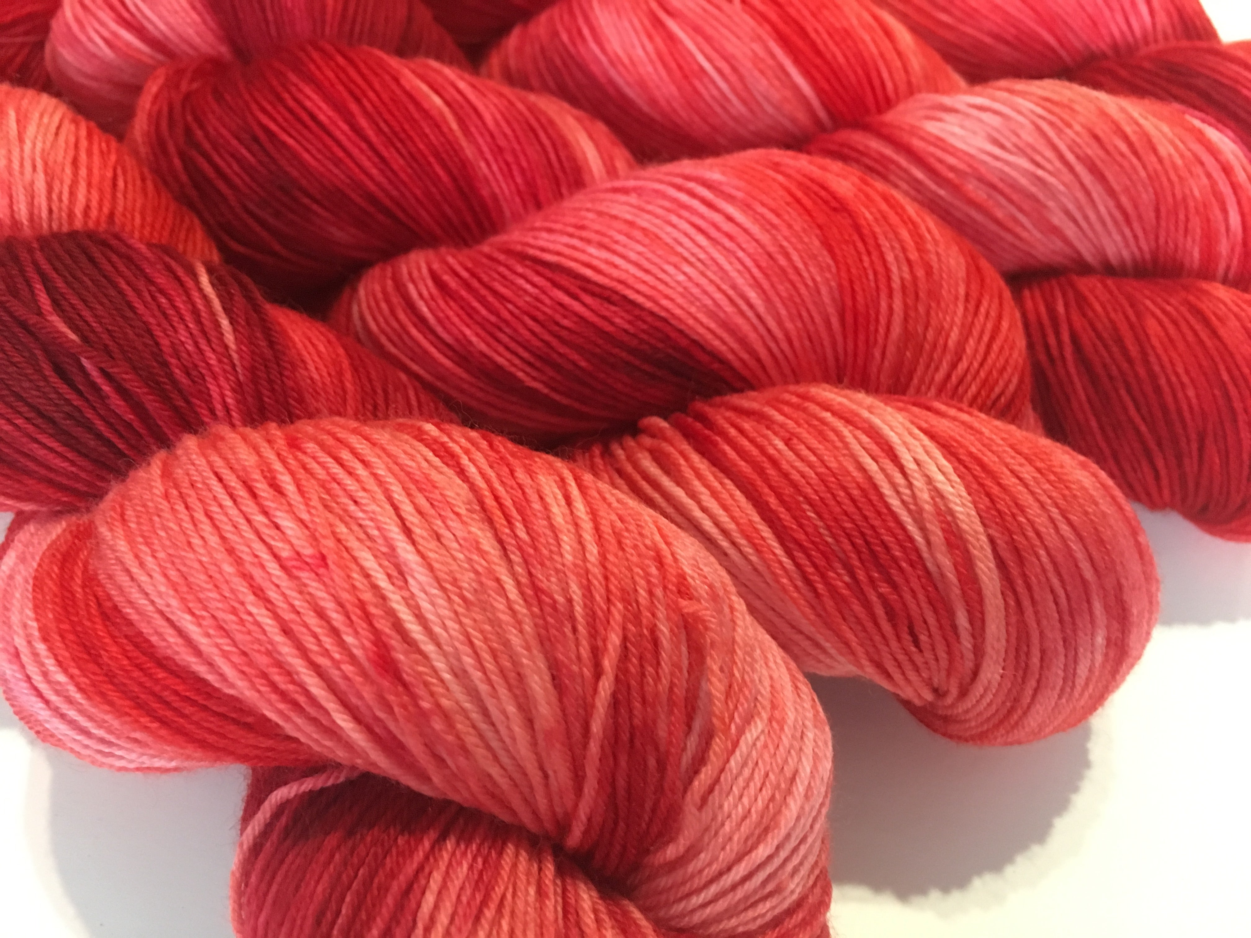kettle dyed tonal red yarn inspired by the hungry caterpillar