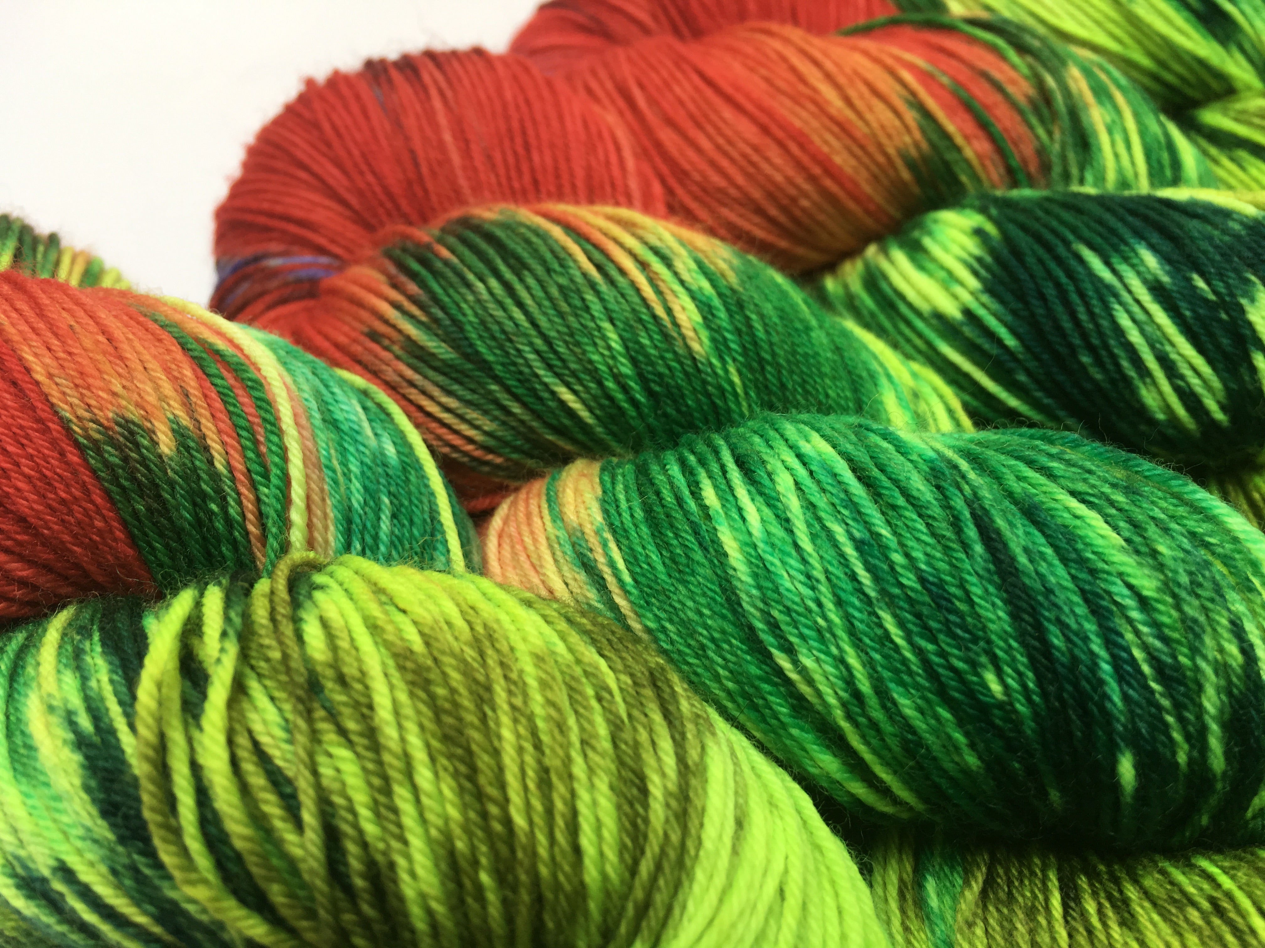 red and green hungry caterpillar merino yarn for weaving and knitting
