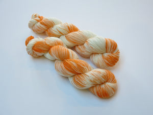indie dyed orange and white superwash merino sock yarn