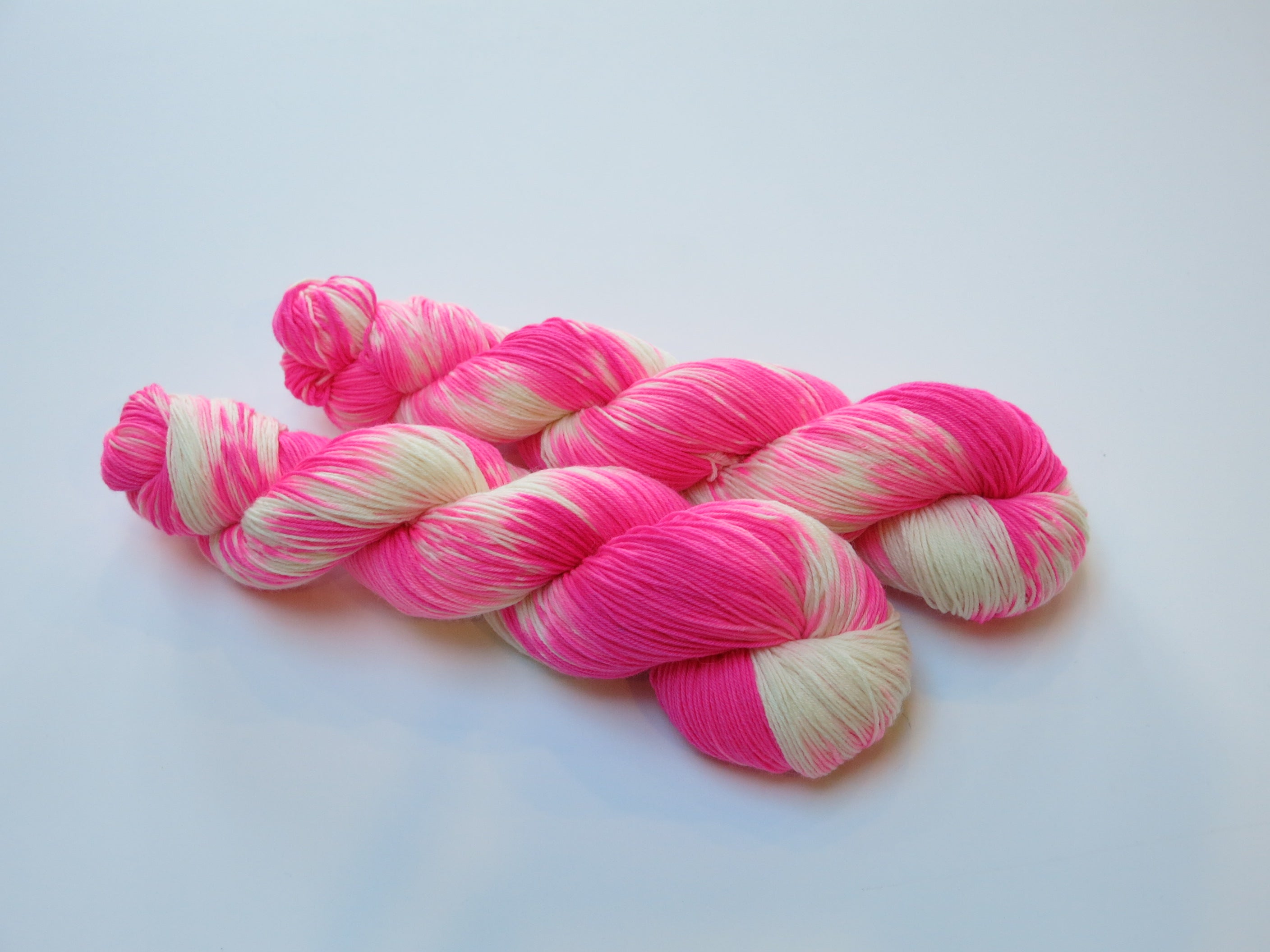 indie dyed uv reactive neon pink superwash merino sock yarn skein