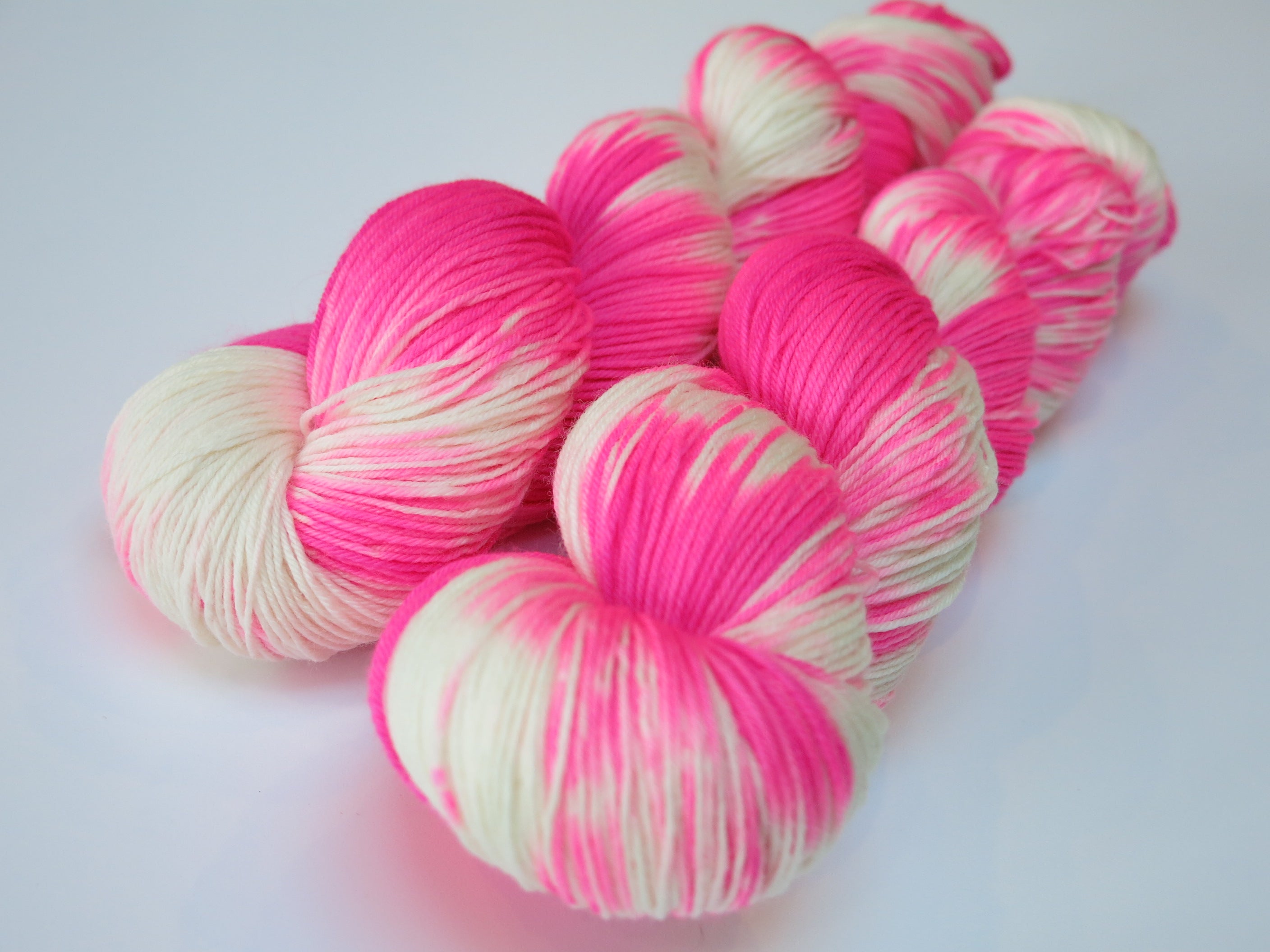 hand dyed uv reactive neon pink merino sock yarn skein