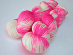 hand dyed uv reactive neon pink merino sock yarn skein