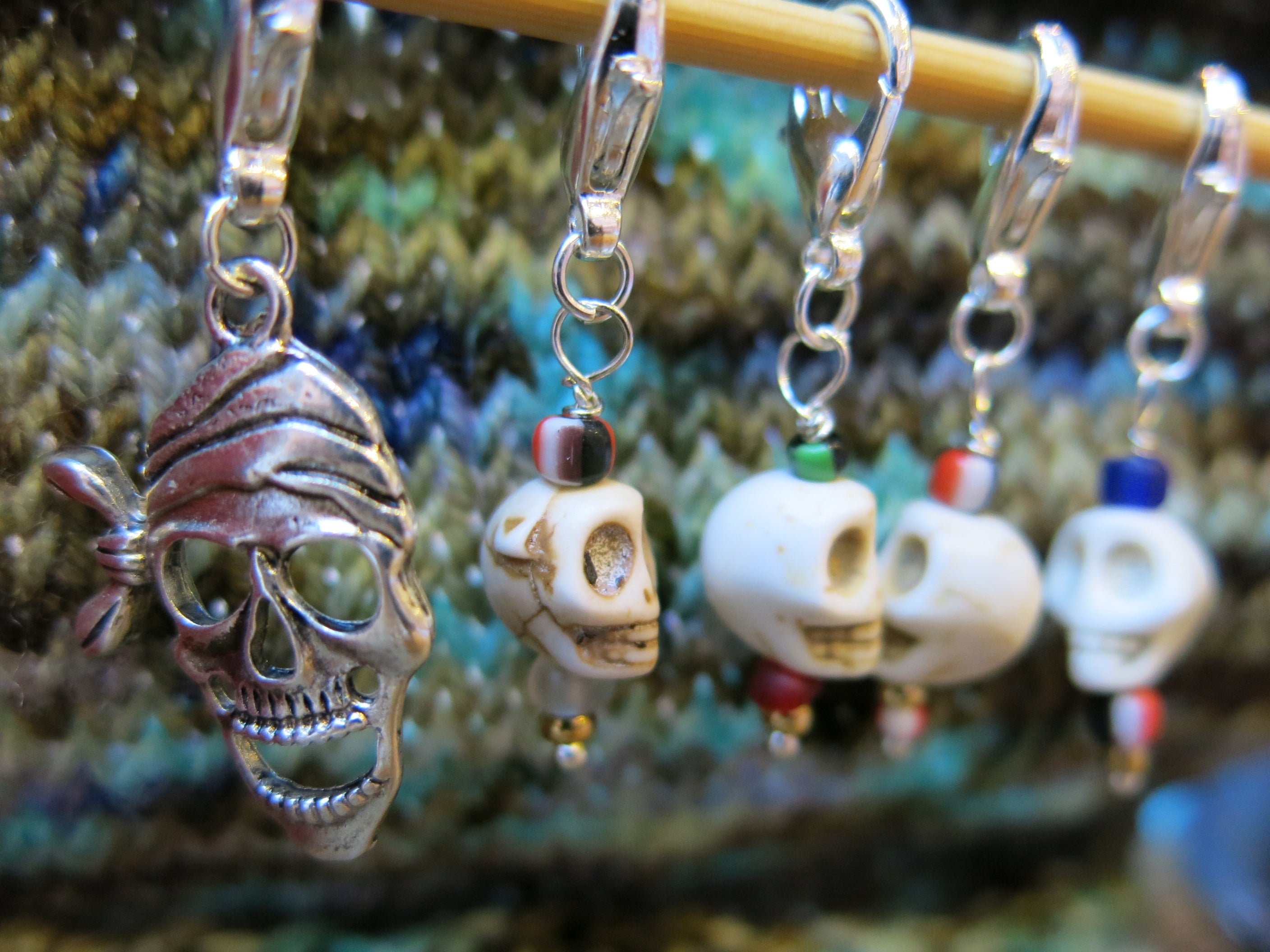 silver pirate stitch marker with white howlite skull charms