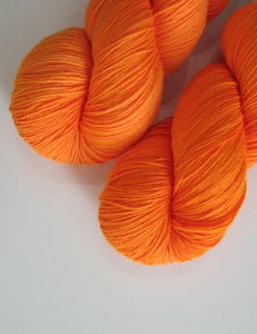 100g skeins of uv reactive orange merino for weaving, knitting and crochet
