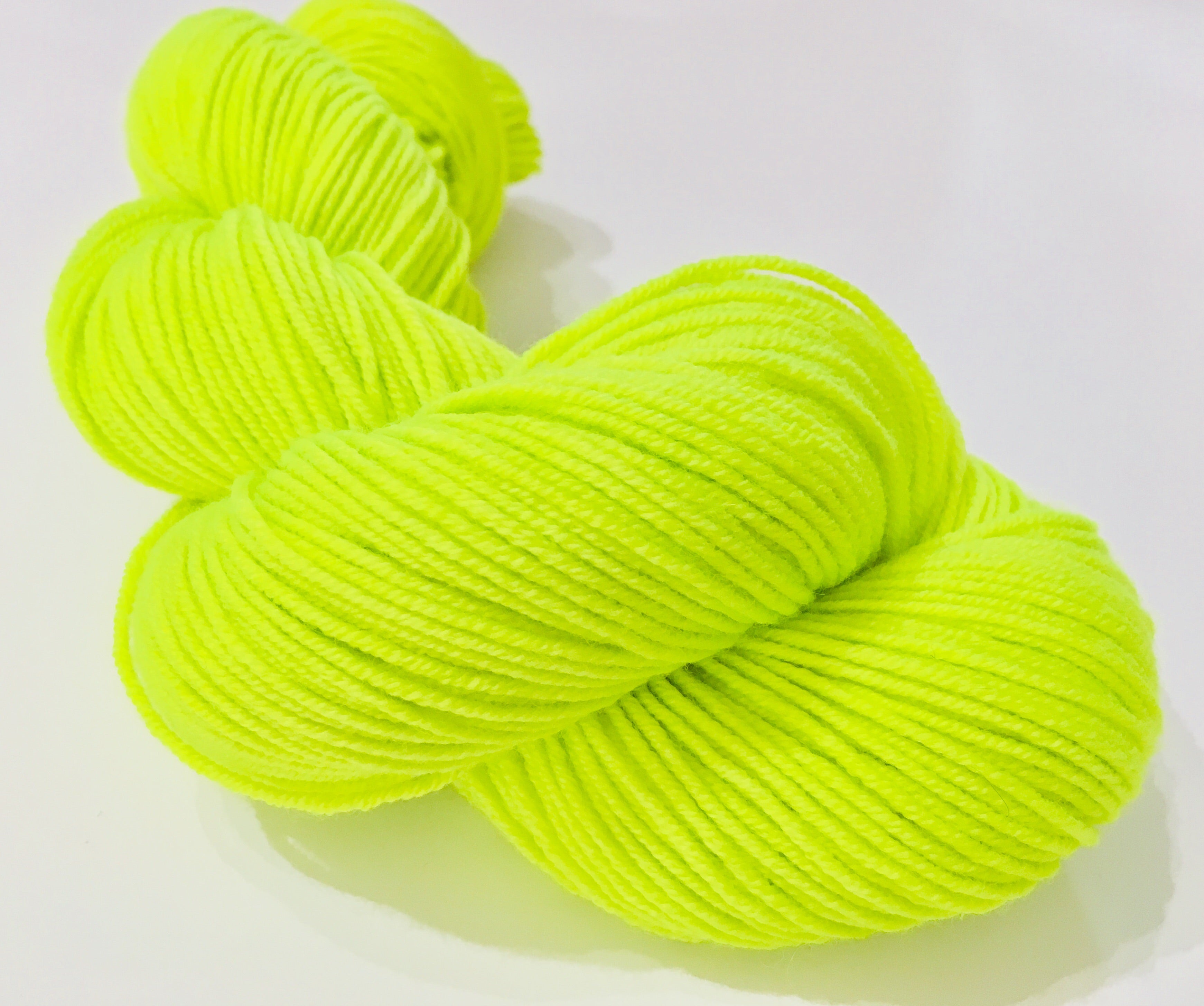 fluorescent neon yarn skein in highlighter yellow green for knitting and crochet
